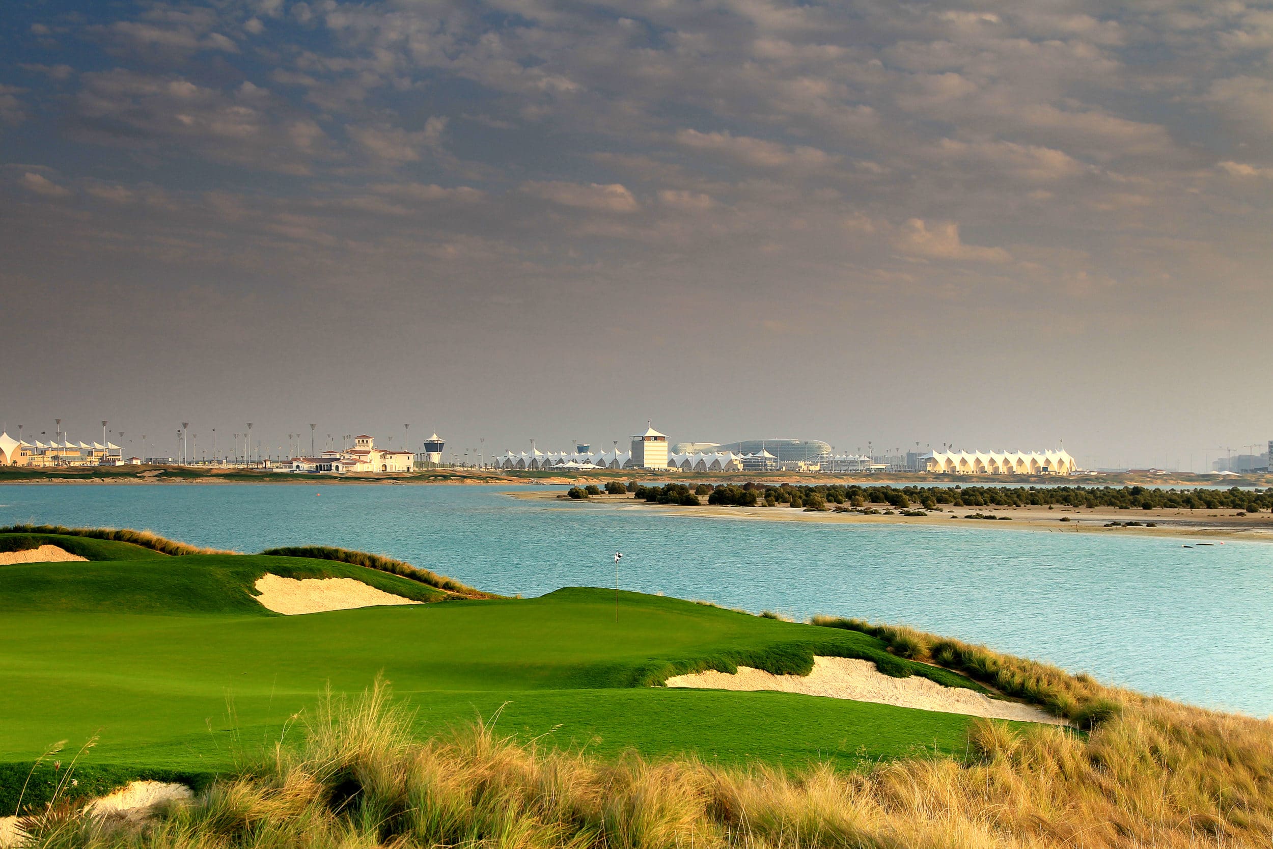 ABU DHABI, UNITED ARAB EMIRATES - JANUARY 26:  A view from behind the green on the par 4, 3rd hole looking back towards the clubhouse and the Yas Island Formula 1 racetrack at Yas Island Golf Club designed by Kyle Phillips of the USA nearing completion on January 26, 2010 in Abu Dhabi, United Arab Emirates.  (Photo by David Cannon/Getty Images)